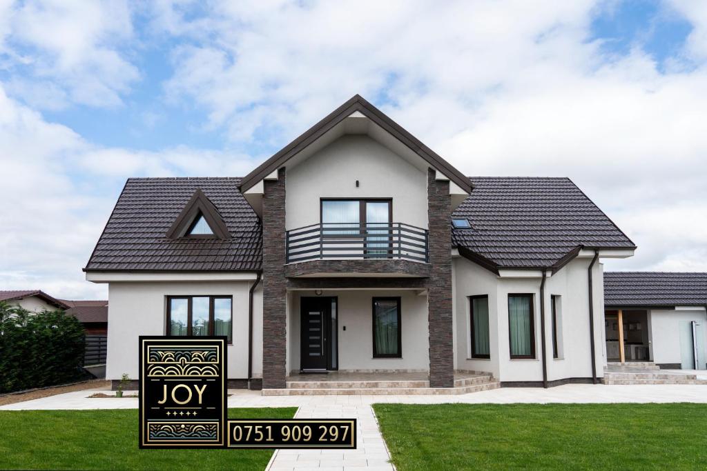 a house with a sold sign in front of it at Pensiunea JOY in Baile Felix