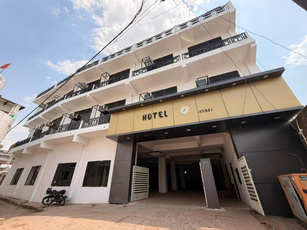 a hotel building with a motorcycle parked in front of it at Hotel A3cube in Panna