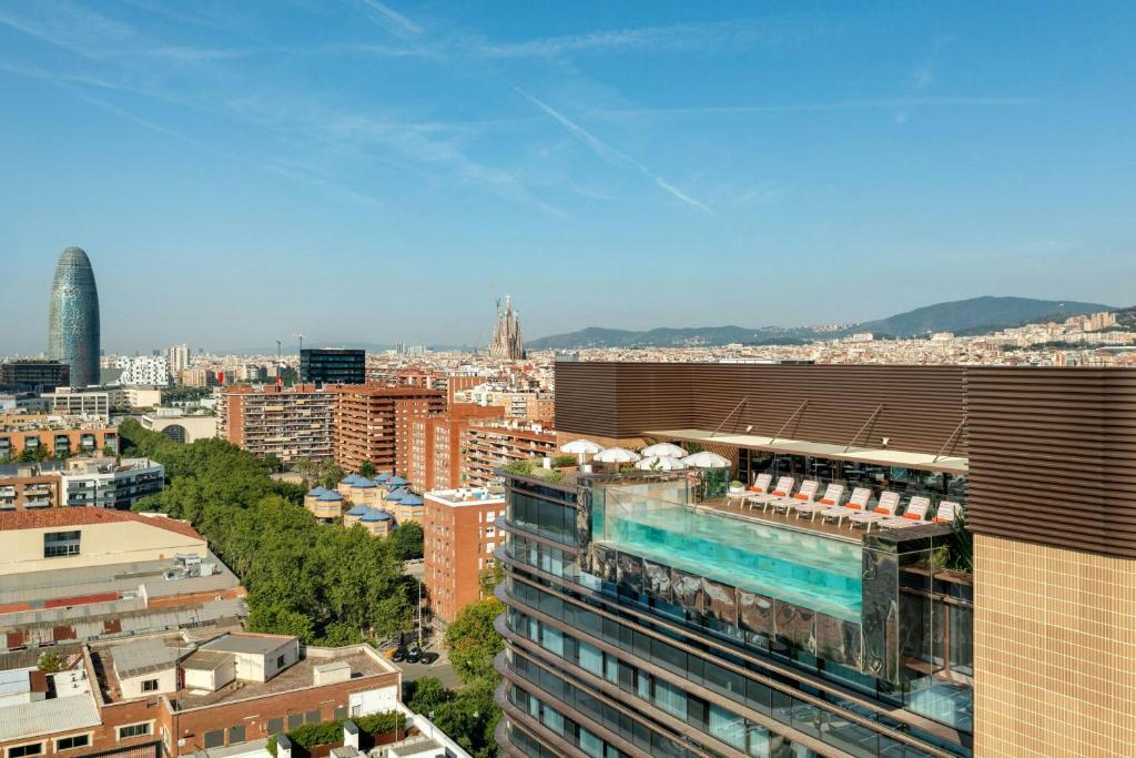 a view of a city with a pool on top of a building at Labtwentytwo Barcelona, a Tribute Portfolio Hotel by Marriott in Barcelona