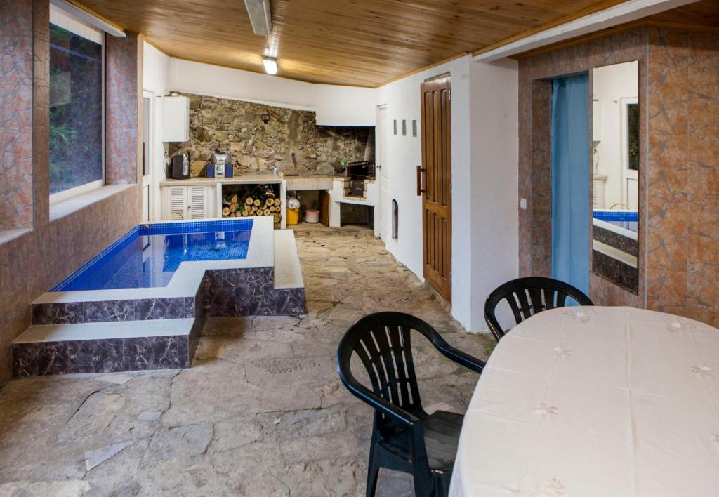 a room with a table and chairs and a swimming pool at Quinta Santo António in Sintra