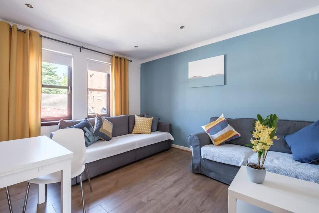 a living room with a couch and a table at The Douglas - Spacious 2 bed apartment in Uddingston in Uddingston