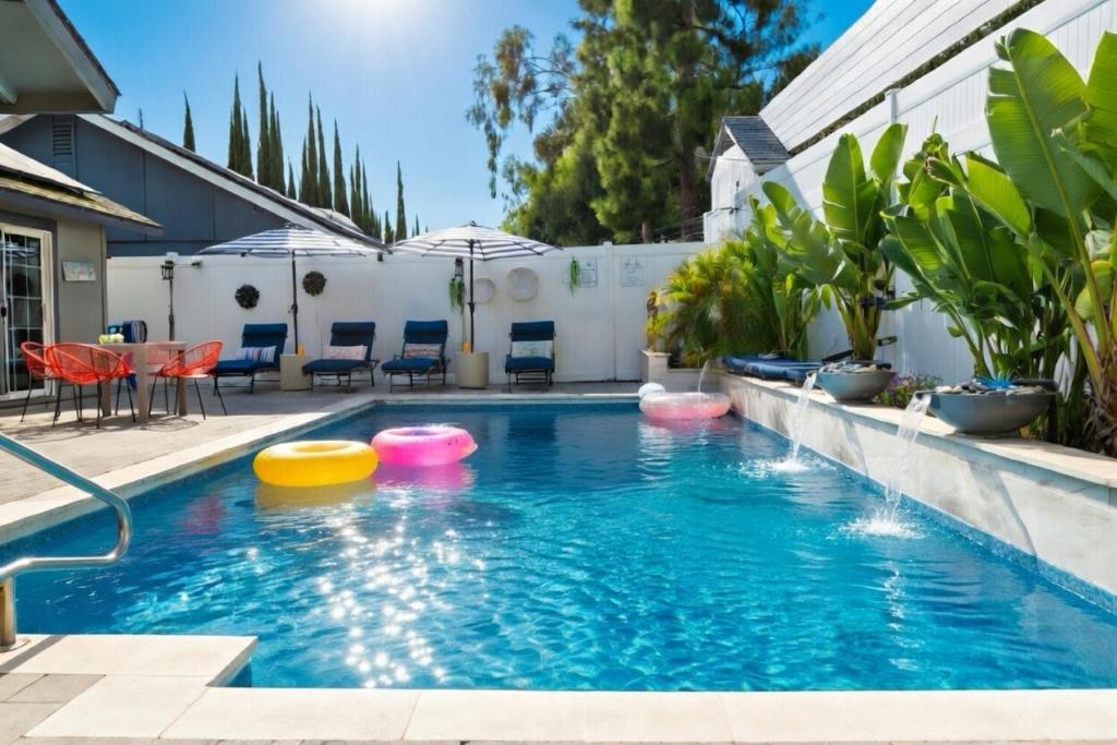 a swimming pool with four frisbees in the water at Laguna oasis Pool, Jacuzzi, Sauna in Laguna Hills