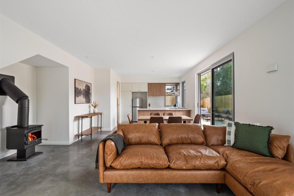 a living room with a couch and a fireplace at The Cape Collective 6 in Margaret River Town