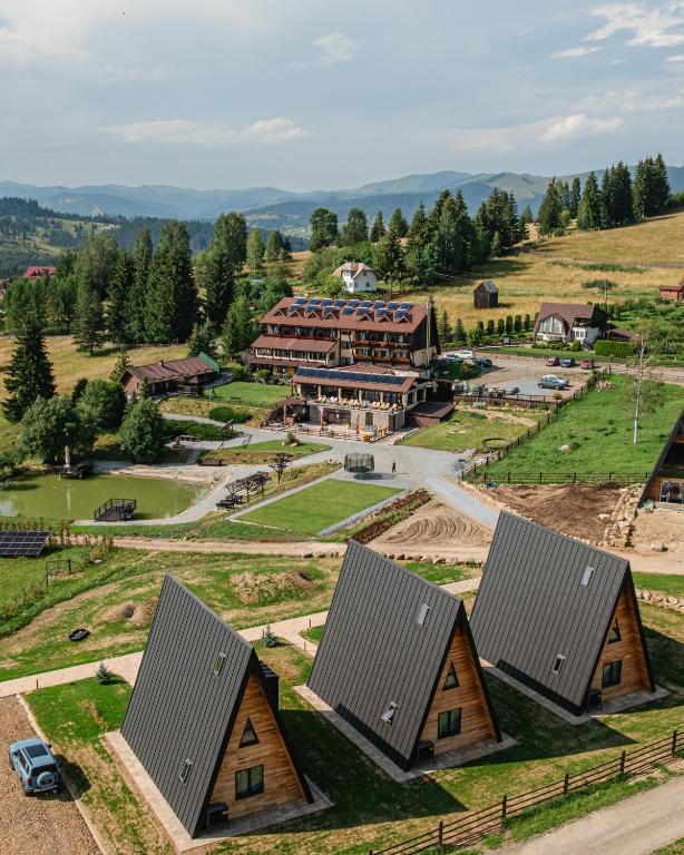 an aerial view of a farm with a building at Pensiunea La Bella Vista in Poiana Negrii