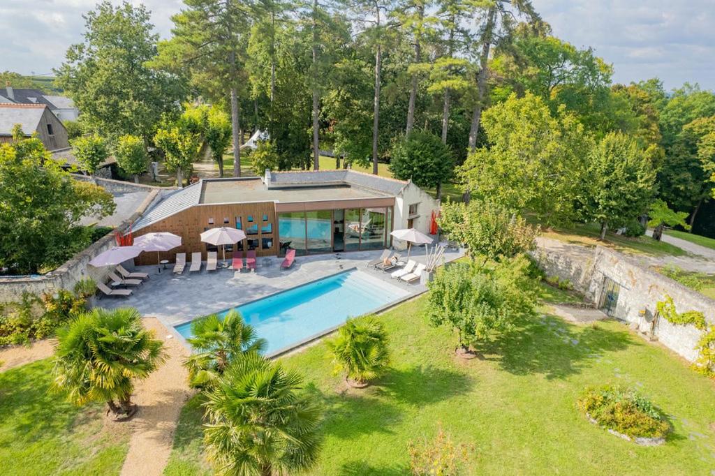 an aerial view of a house with a swimming pool at Château de Candes - Art & Spa in Candes-Saint-Martin