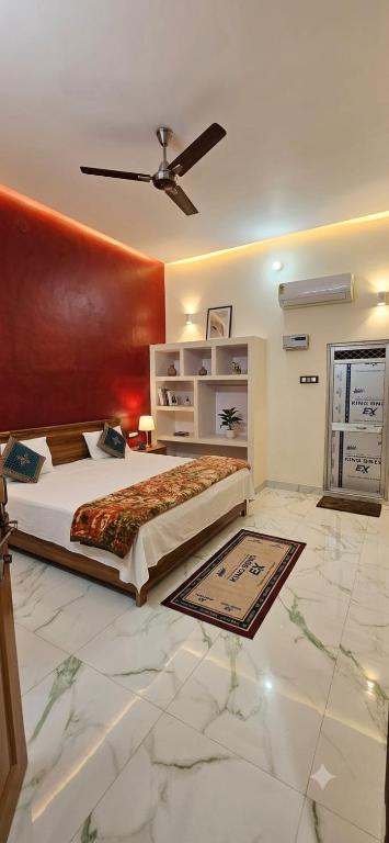 a bedroom with a large bed and a ceiling at Hotel Shree Rameshwaram Near by All Temple in Ayodhya