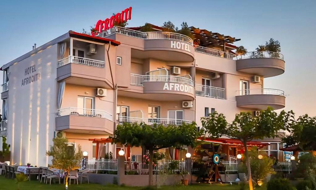 a large building with a hotel on top of it at Afroditi Hotel in Paralia Katerinis