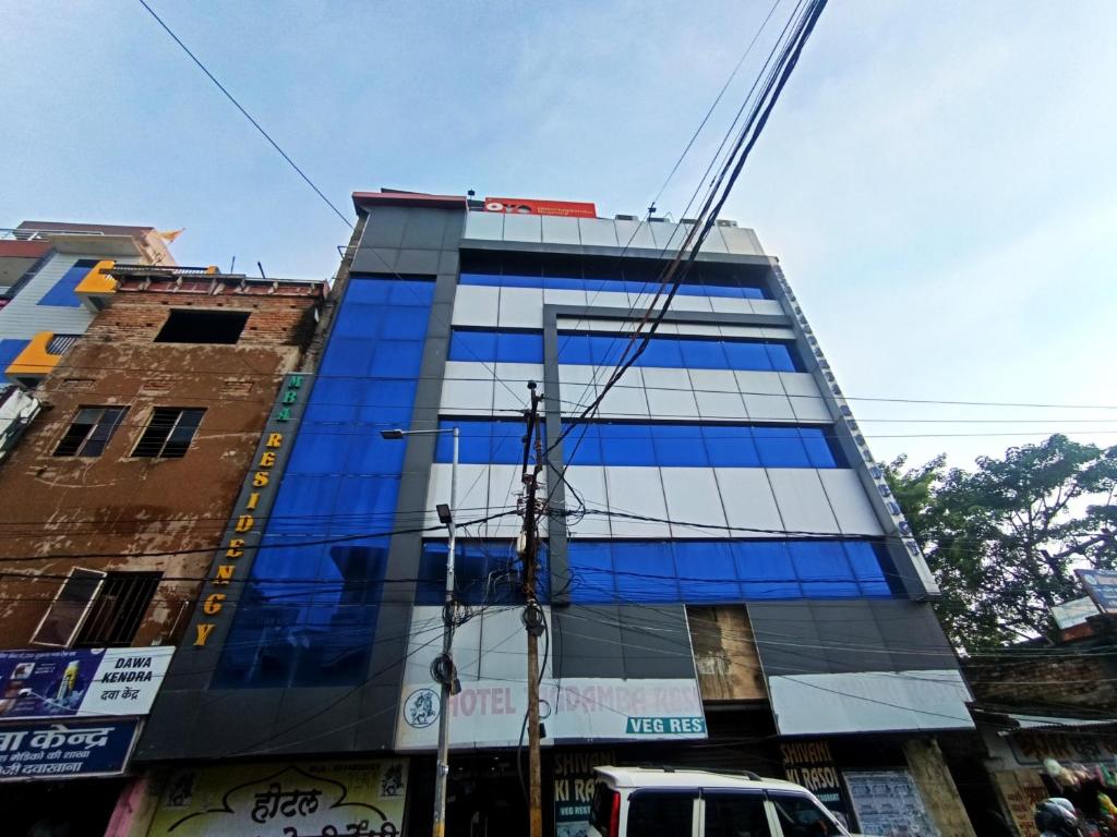 a building with blue glass windows on a city street at Hotel Jagdamba Residency in Chupra