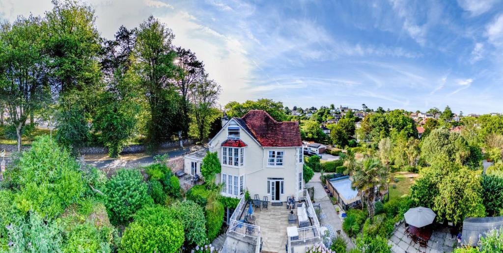 an aerial view of a white house with a pool at The Charterhouse in Torquay