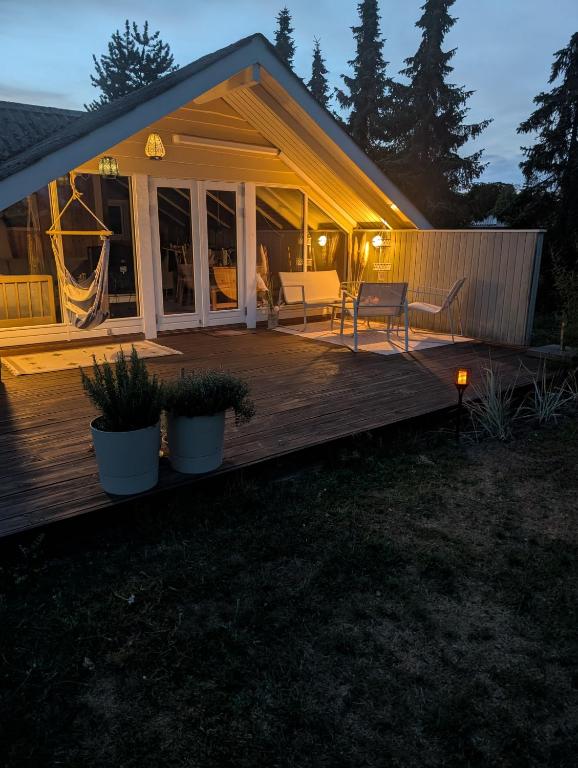 a house with a wooden deck at night at Marielyst Summer House in Bøtø By