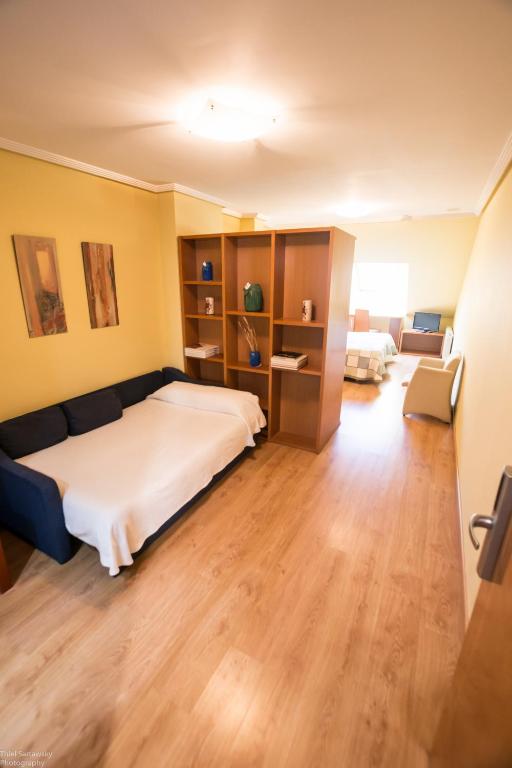 Postel nebo postele na pokoji v ubytování Hotel El Roble