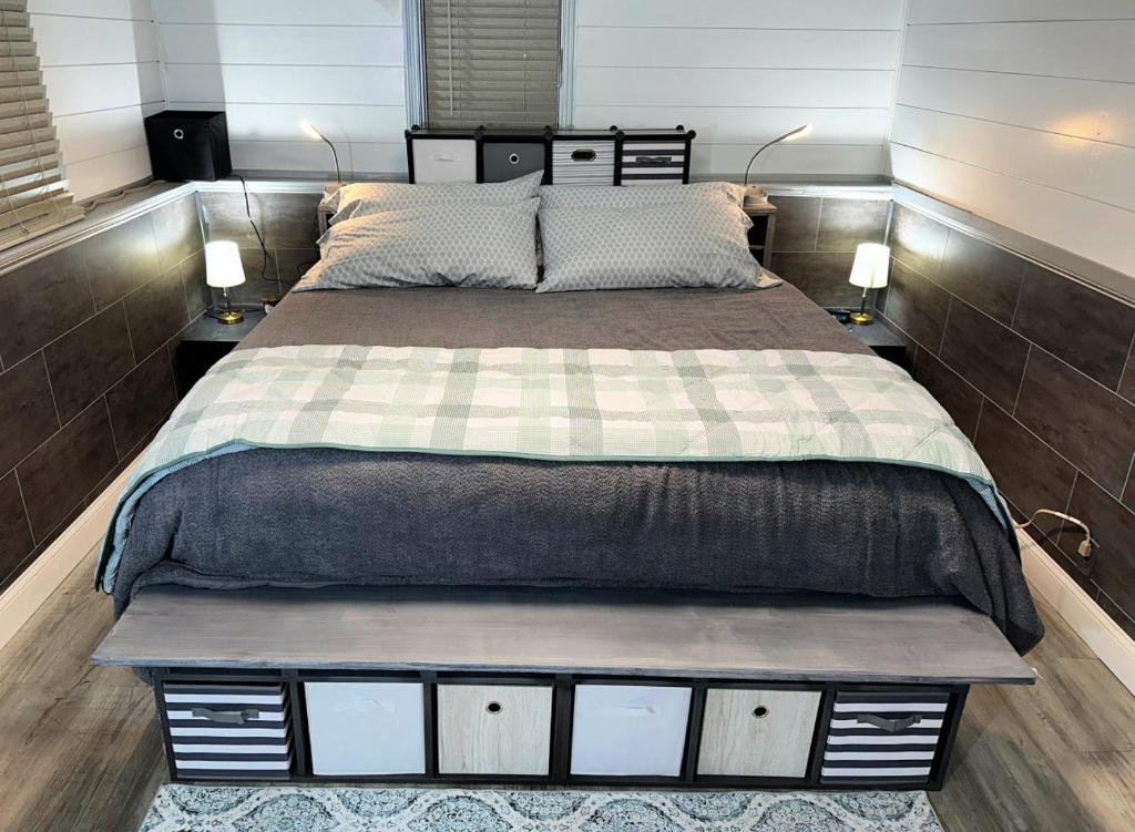 a bedroom with a large bed with two lamps on both sides at The Hideout in Moorhead