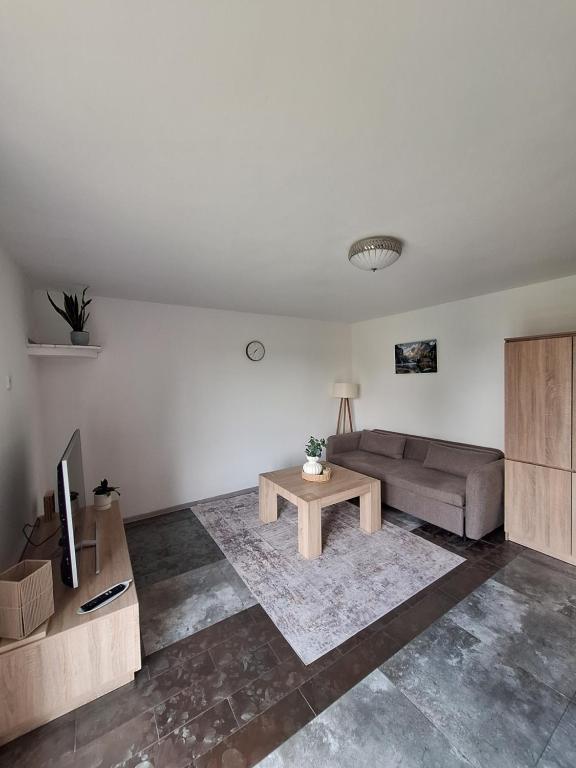 a living room with a couch and a coffee table at Apartament Alicja in Chmielno