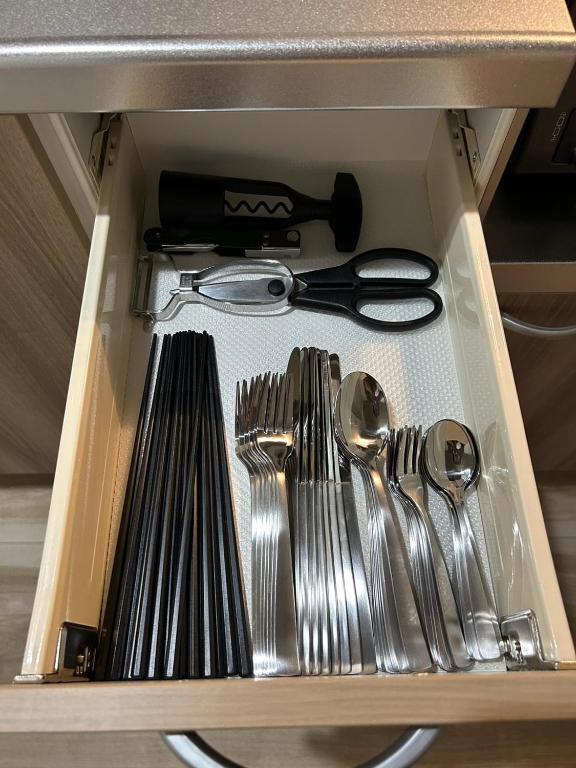 a drawer filled with silver utensils and spoons at koharubi hanada in Murochō