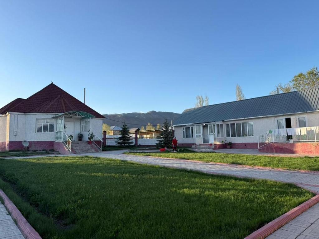 a row of houses with a grass yard at Ayara home in Kyzart