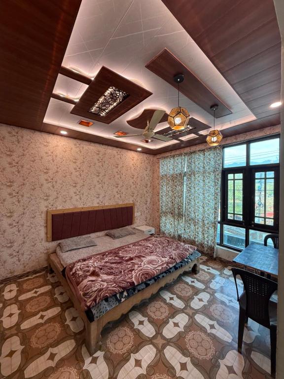 a bedroom with a bed and a table and windows at Lakes and peaks in Srinagar