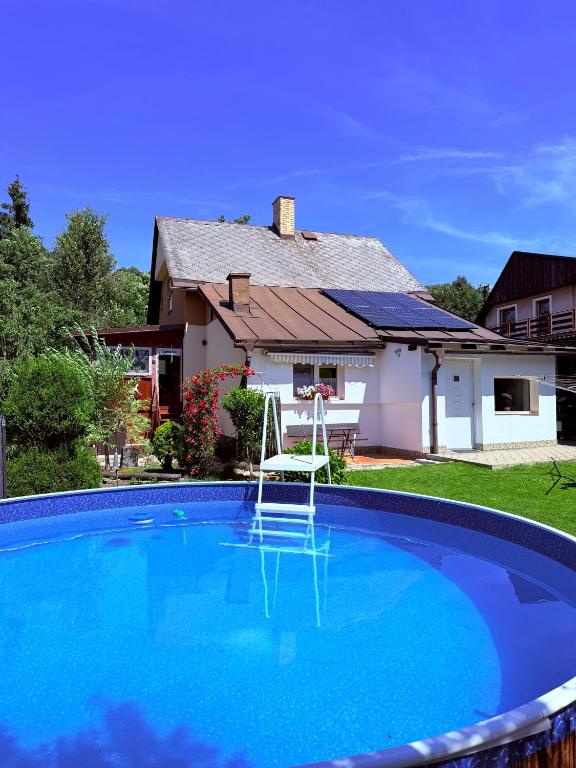 a swimming pool in front of a house at u Vlastika in Jeseník