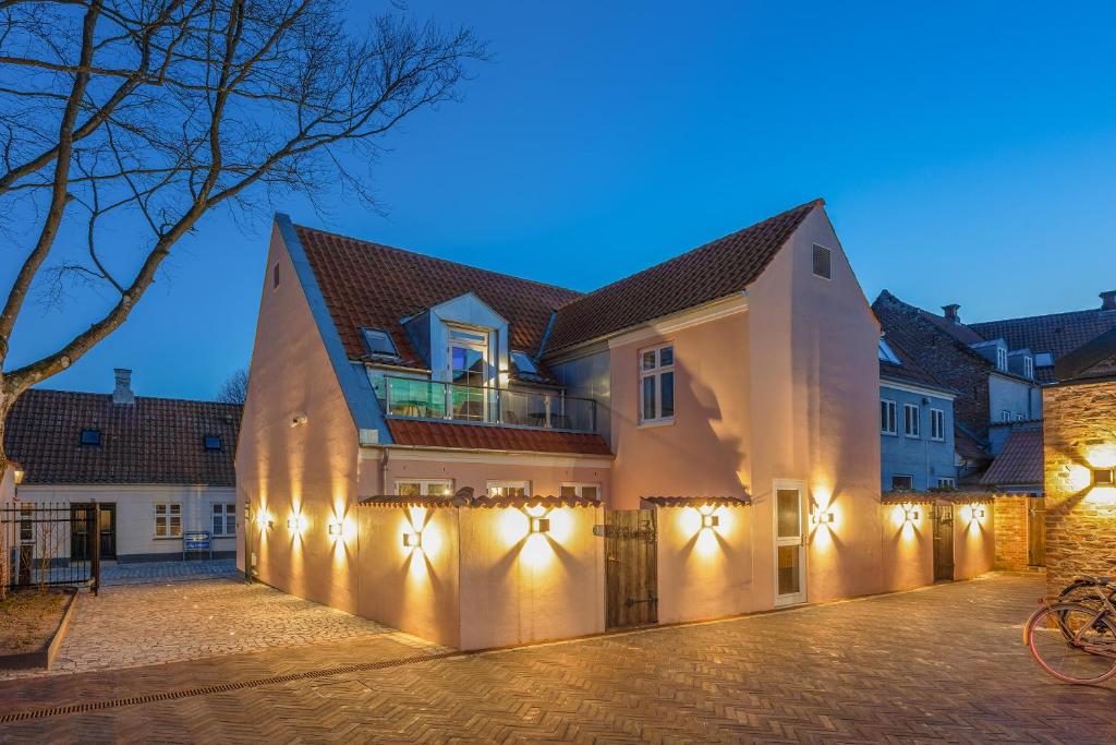 a building with lights on it at night at Hotel Varde Garten in Varde