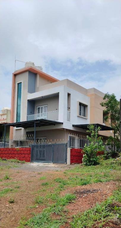 a house with a fence in front of it at Wale's Hilltop Villa in Kolhapur