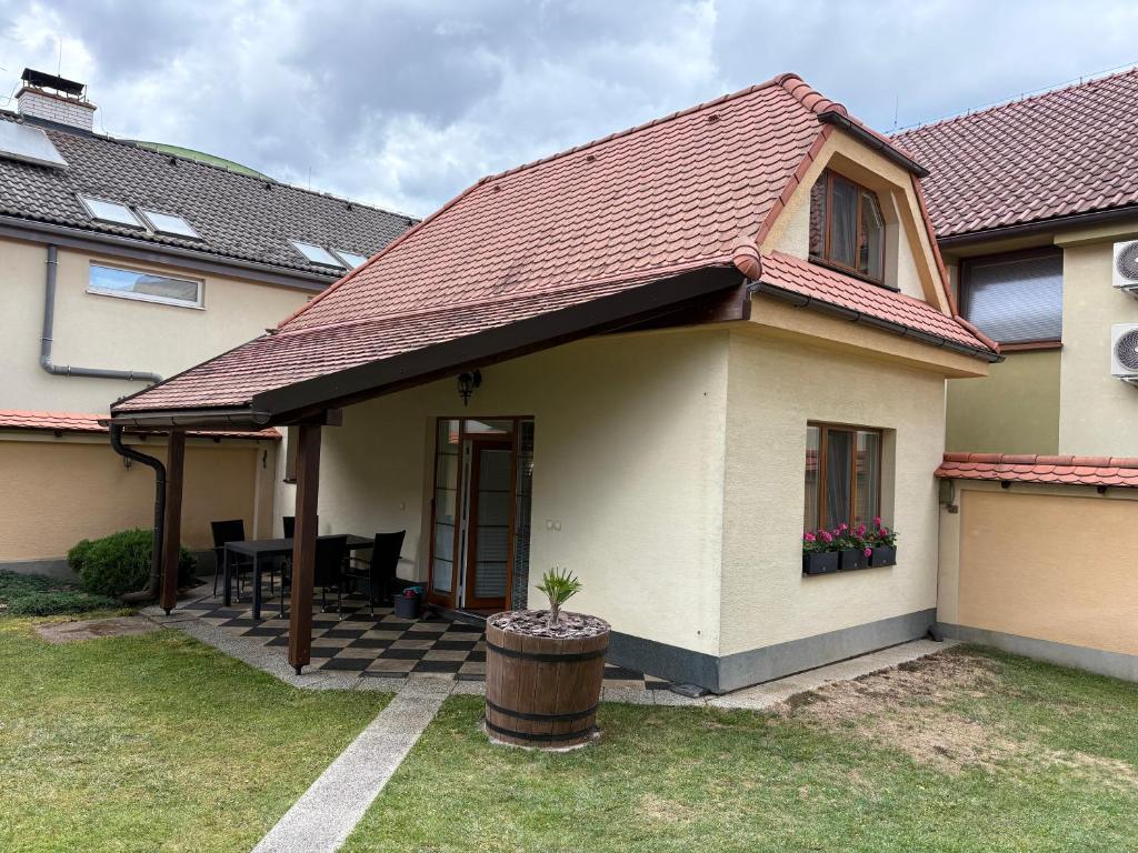a house with a red roof with a patio at RRR Apartmány in Bojnice