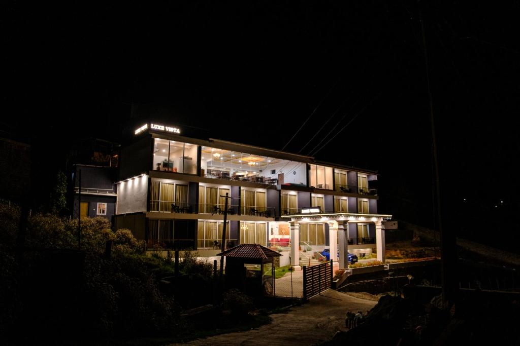 a building at night with its lights on at Luxe Vista Resort Kodai in Kodaikānāl