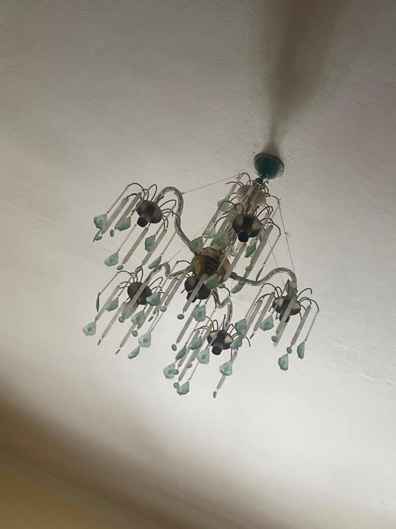 a chandelier is hanging from a ceiling at Appartement in Jemaa de Mrirt