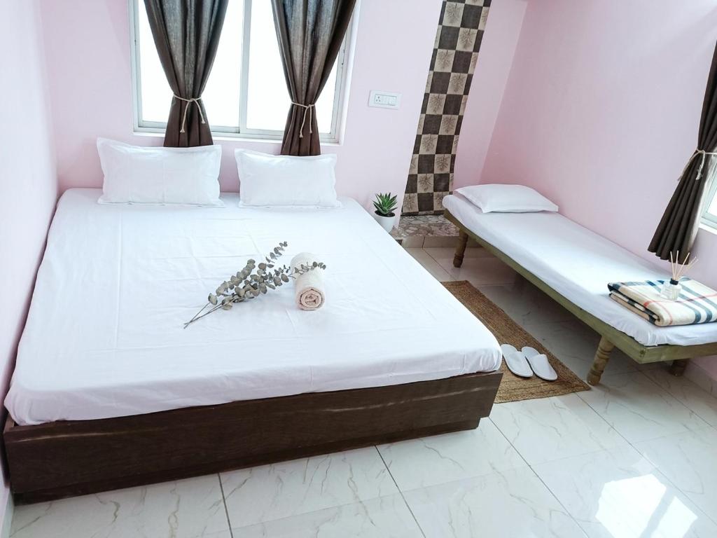 a bedroom with a bed and a bench in a room at Shiva Homestay Dwarka in Dwarka