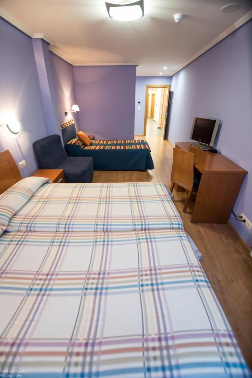 Postel nebo postele na pokoji v ubytování Hotel El Roble