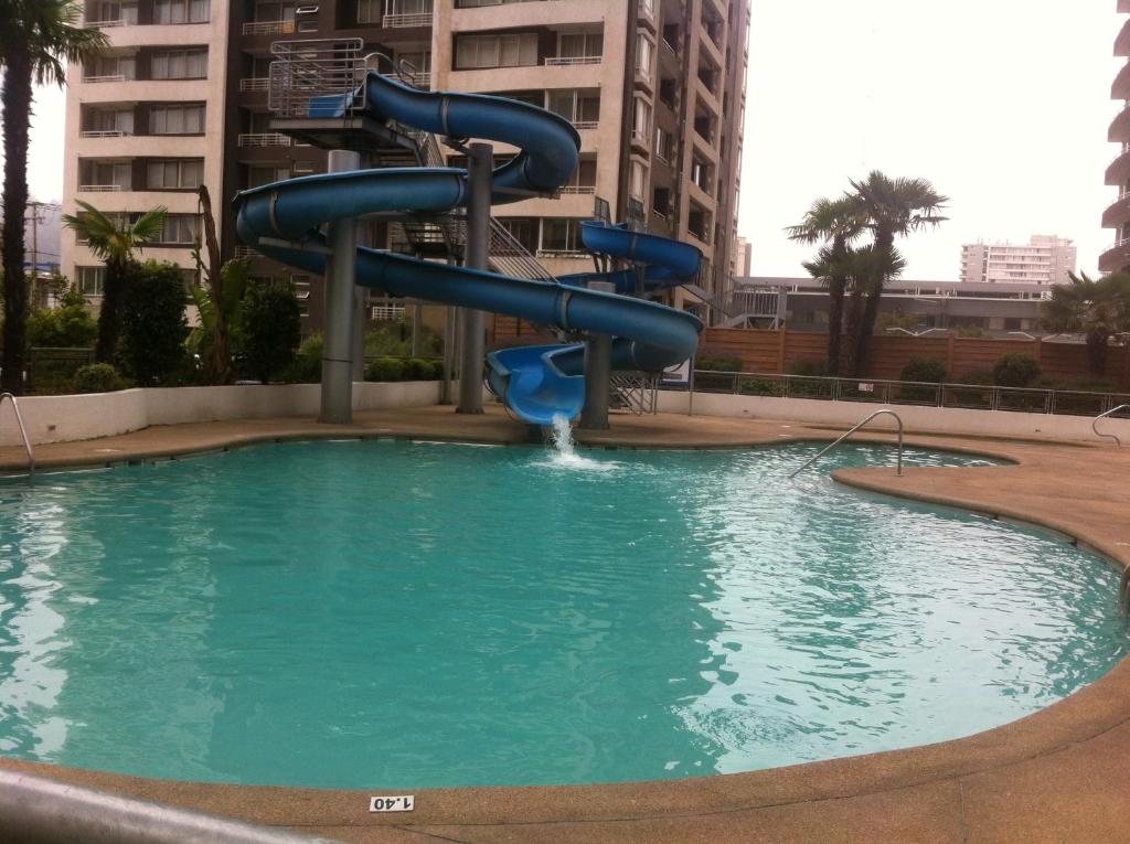a water slide in a pool in a city at Departamento Viana in Viña del Mar