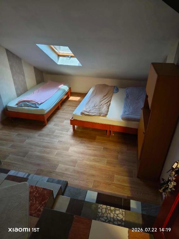 a bedroom with two beds and a window at Centrum Panzió VIP in Kaposvár