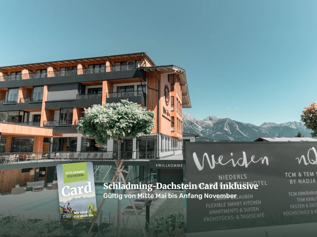 a building with a sign in front of it at Apart & Suiten Hotel WEIDEN in Schladming