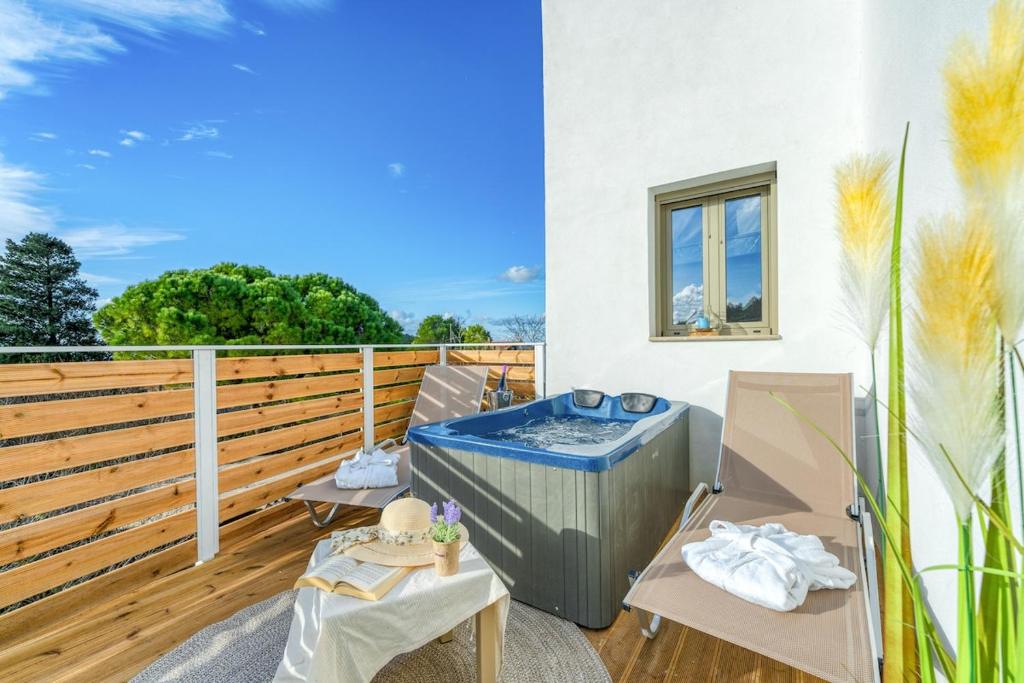 a hot tub on the balcony of a house at Luminoza Villa Zakynthos in Volímai