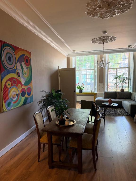 a living room with a table and a couch at historic city apartment with private parking in Gouda