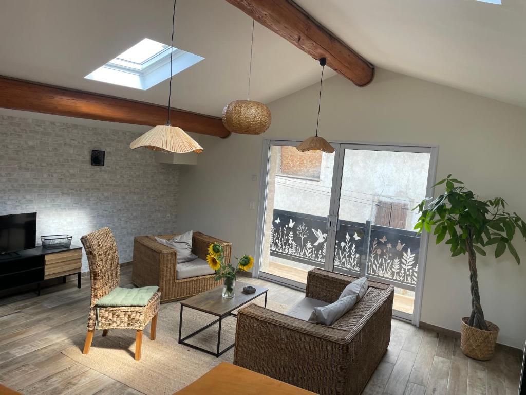 a living room with a couch and a table at Le petit chalet in Luc-en-Diois