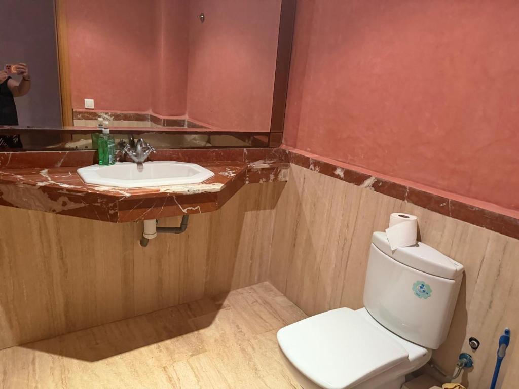 a bathroom with a white toilet and a sink at Blu capri in Dar Bouazza