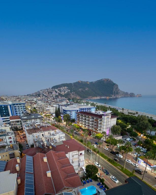 an aerial view of a city and the ocean at Miray Hotel Kleopatra in Alanya