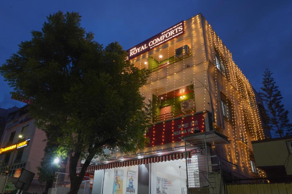 a building with christmas lights on the side of it at Hotel Royal Comforts in Pune