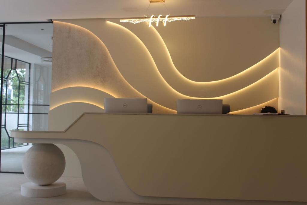 a white bench in a room with lights on the wall at Hotel Radhe Imperial in Hyderabad