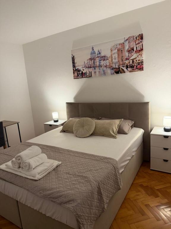 a bedroom with a bed with two towels on it at Emama Residence Mostar in Mostar