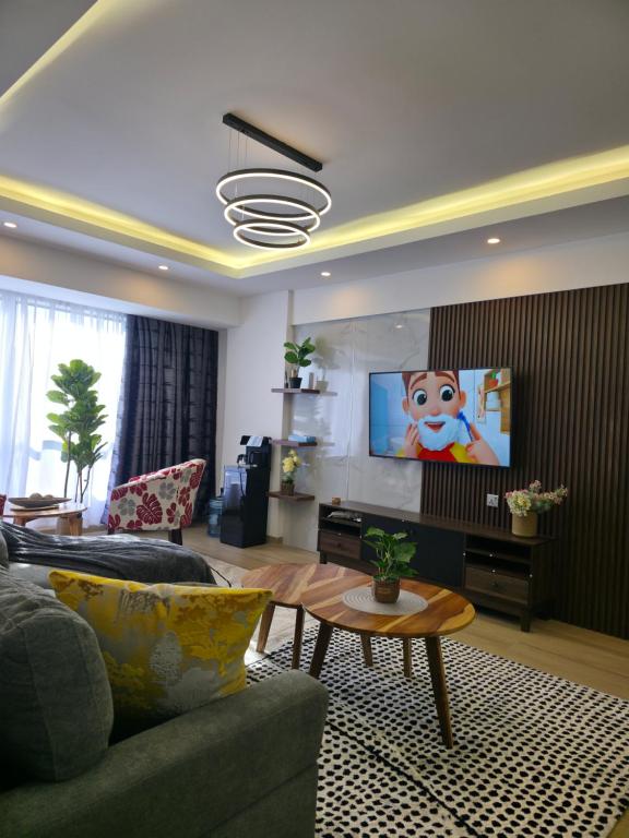 a living room with a couch and a tv at Haven 2 lustic in Nairobi