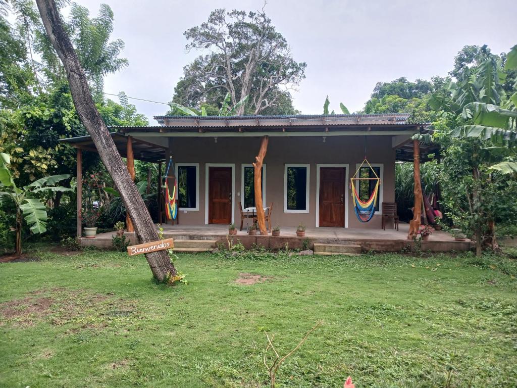 a small house with a tree in front of it at Sunny Garden Lodge in Mérida