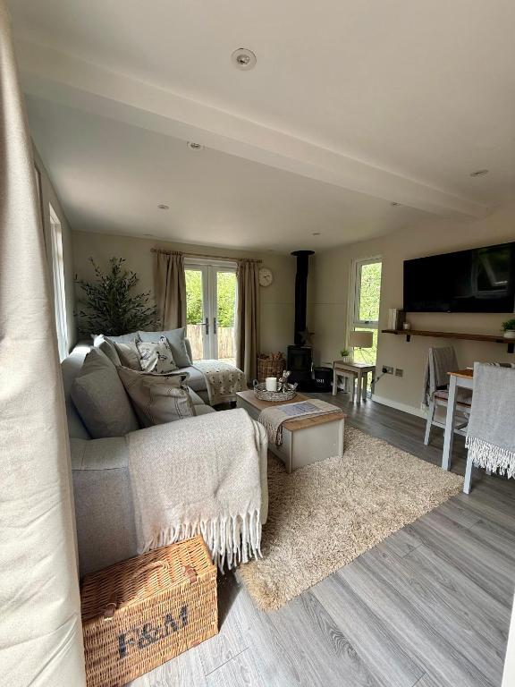 a living room with a couch and a table at The Willow Luxury Countryside Retreat in Stone
