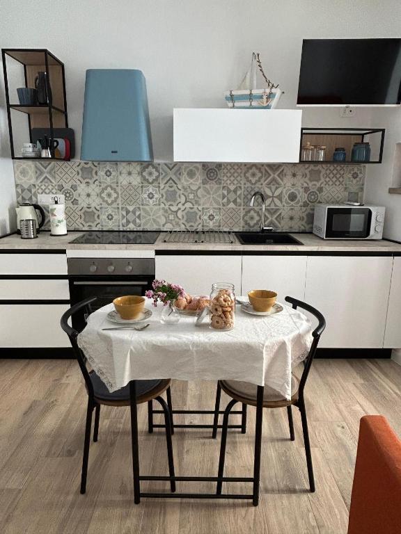 a table with two bowls on it in a kitchen at Il Timone e L'Ulivo in Moneglia