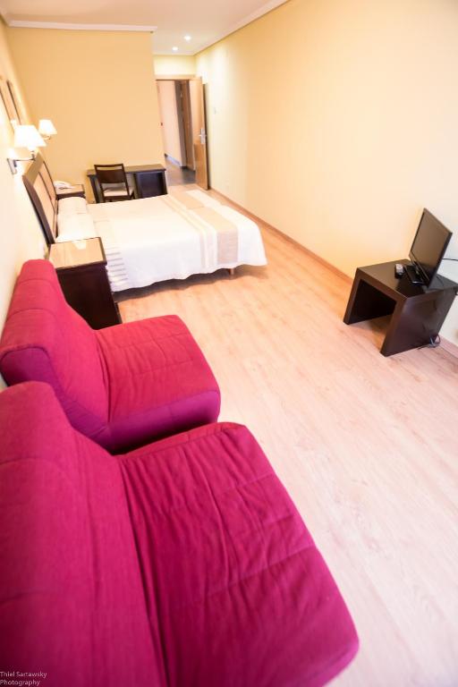 Postel nebo postele na pokoji v ubytování Hotel El Roble