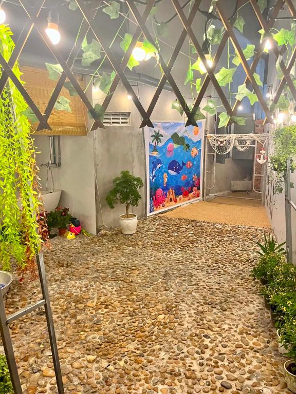 a room with a wall with a painting of an aquarium at Cát Home in Phú Hiệp