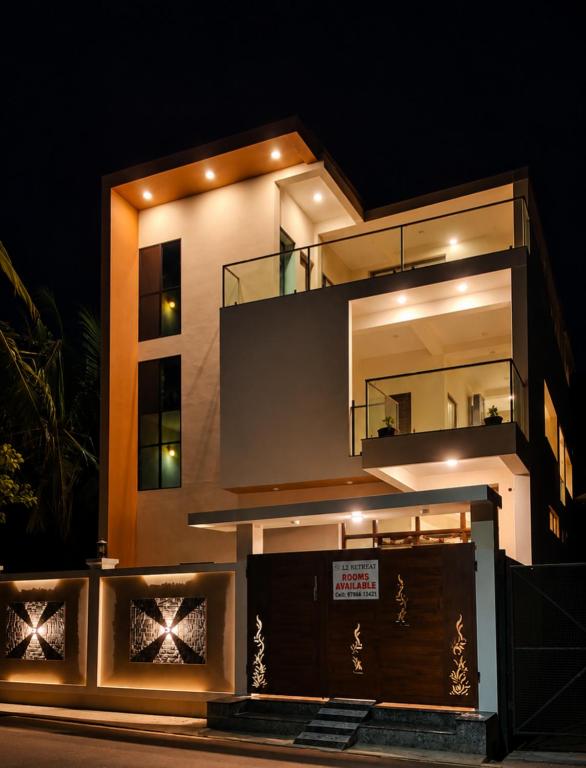 a night view of a large building with a balcony at L2 Retreat in Kottakupam