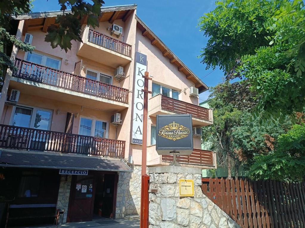 a building with a sign in front of it at Korona Panzió Budapest in Budapest