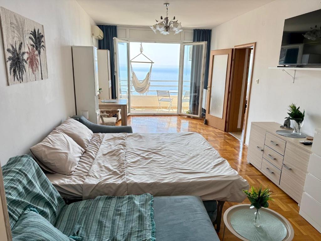 a bedroom with a bed and a view of the ocean at Sea Time Apartment in Budva