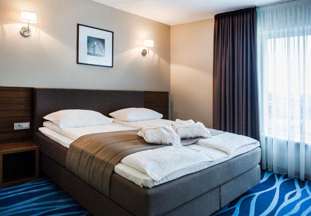 Postel nebo postele na pokoji v ubytování Hotel Porto