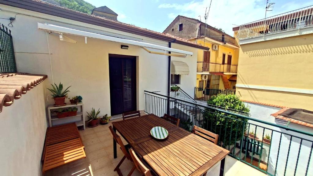 a balcony with a wooden table and benches on it at Mamè Guest House in Figlino